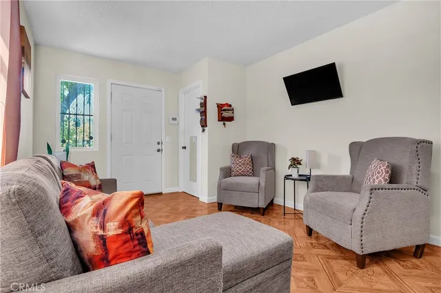 a bedroom with furniture and a flat screen tv