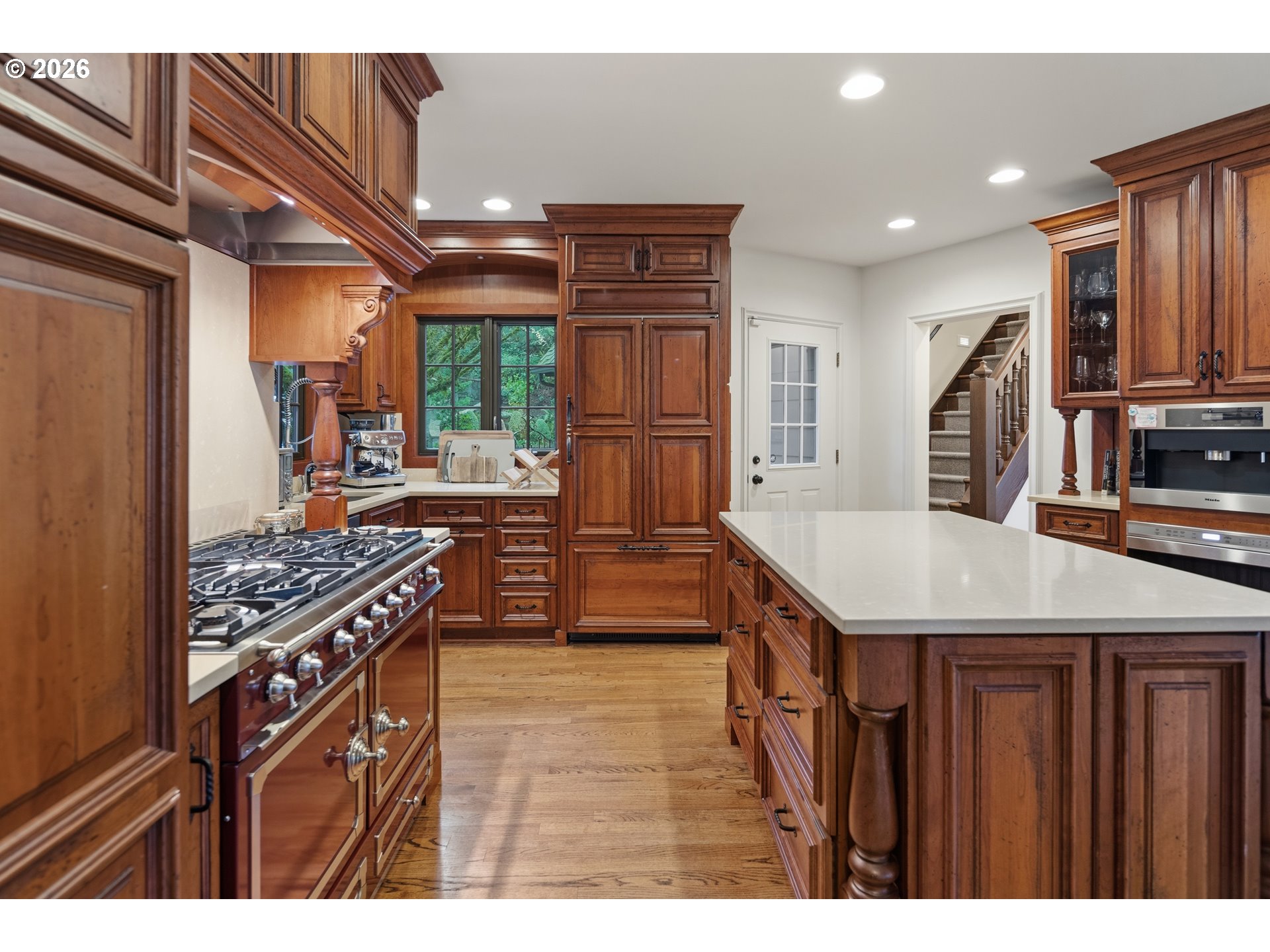2897 Southwest Rutland Terrace Portland, OR 97205 - Photo 19 of 46 a kitchen that has a kitchen island wooden cabinets and stainless steel appliances