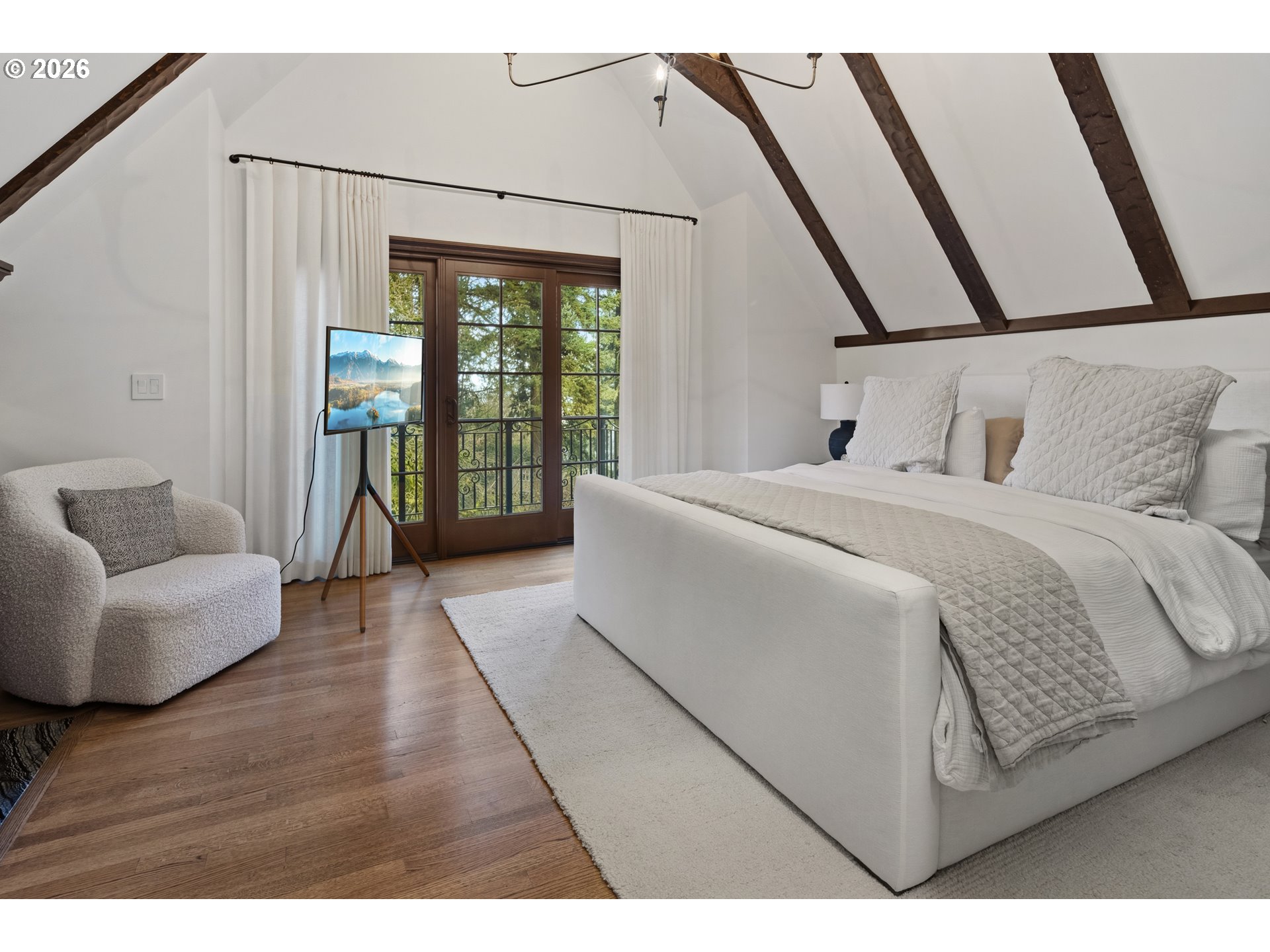 2897 Southwest Rutland Terrace Portland, OR 97205 - Photo 26 of 46 a bedroom with a bed couch and a large window