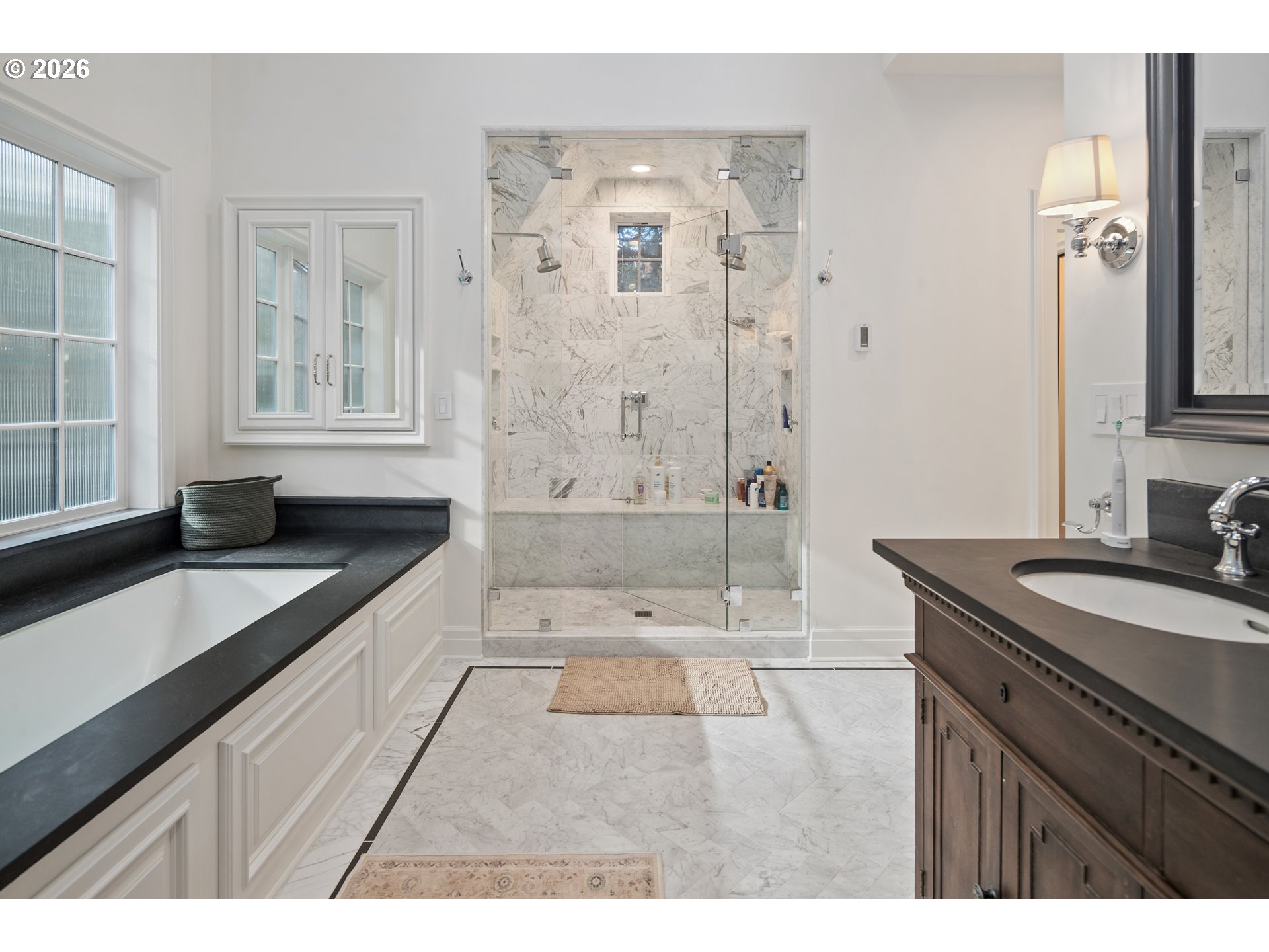 2897 Southwest Rutland Terrace Portland, OR 97205 - Photo 29 of 46 a bathroom with a granite countertop sink a toilet a mirror and shower
