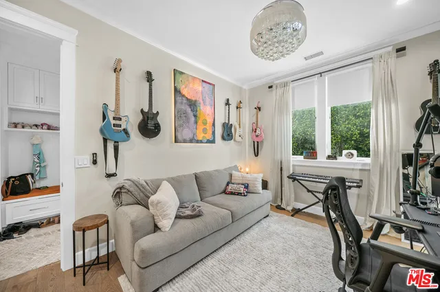 a bedroom with furniture and a large window