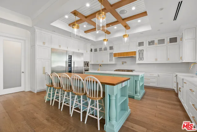 a kitchen with stainless steel appliances granite countertop a sink and a refrigerator