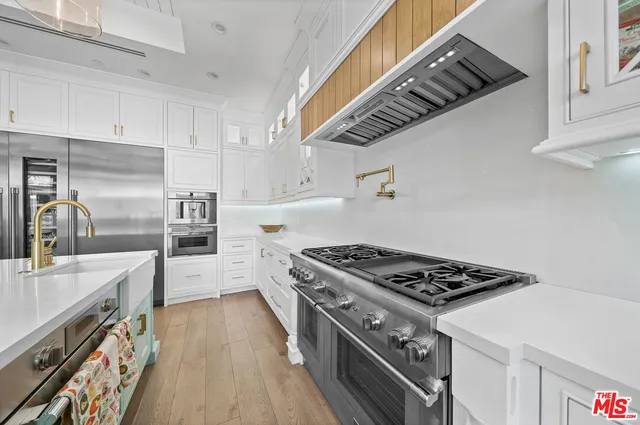 a kitchen with granite countertop a stove and a sink