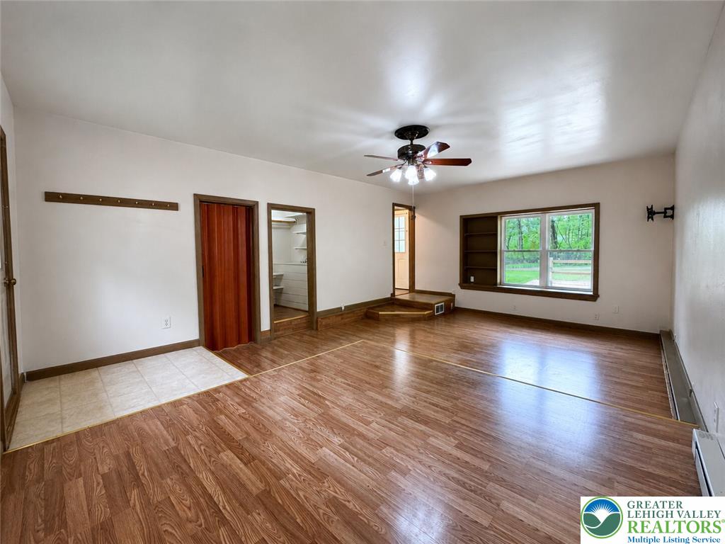 4995 Mountain Road Slatington, PA 18080 - Photo 13 of 30 A versatile living area with wood-look flooring and built-in shelving awaits your personal touch.