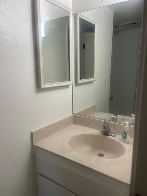 5301 East Waverly Drive, Unit 218 Palm Springs, CA 92264 - Photo 4 of 7 a bathroom with a sink and a mirror