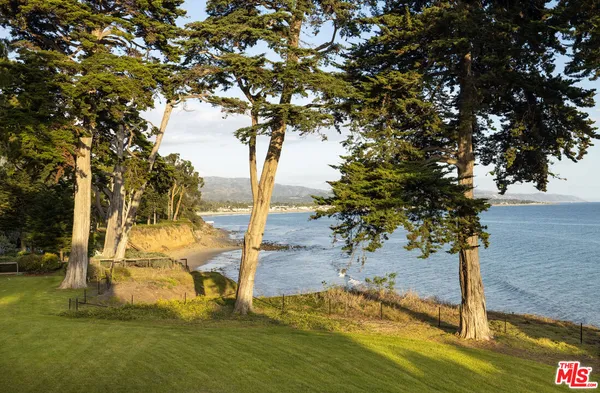 a bathroom with a granite countertop sink a large mirror and a bathtub