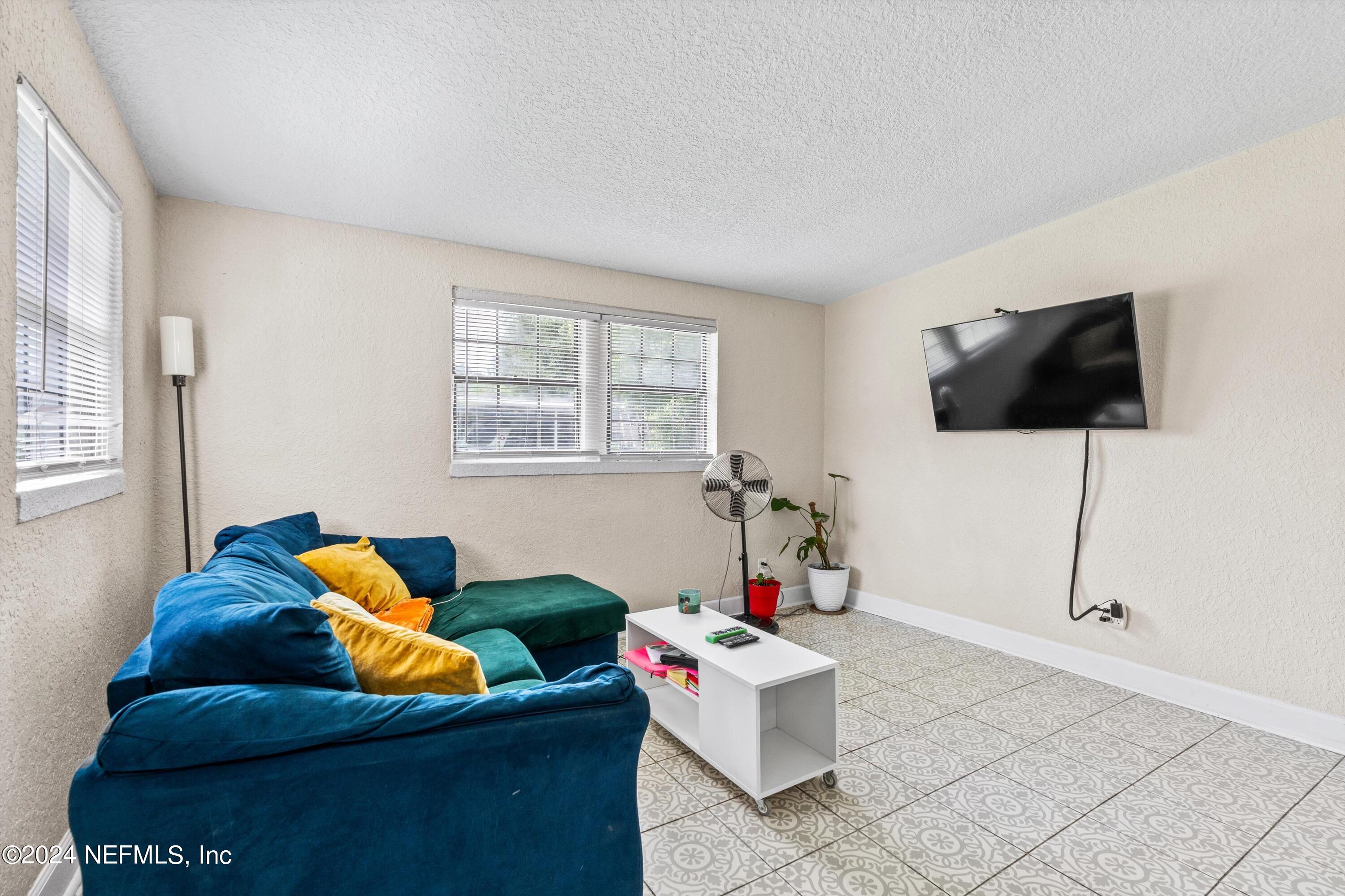 1824 Griflet Road Jacksonville, FL 32211 - Photo 3 of 19 a living room with furniture and a flat screen tv
