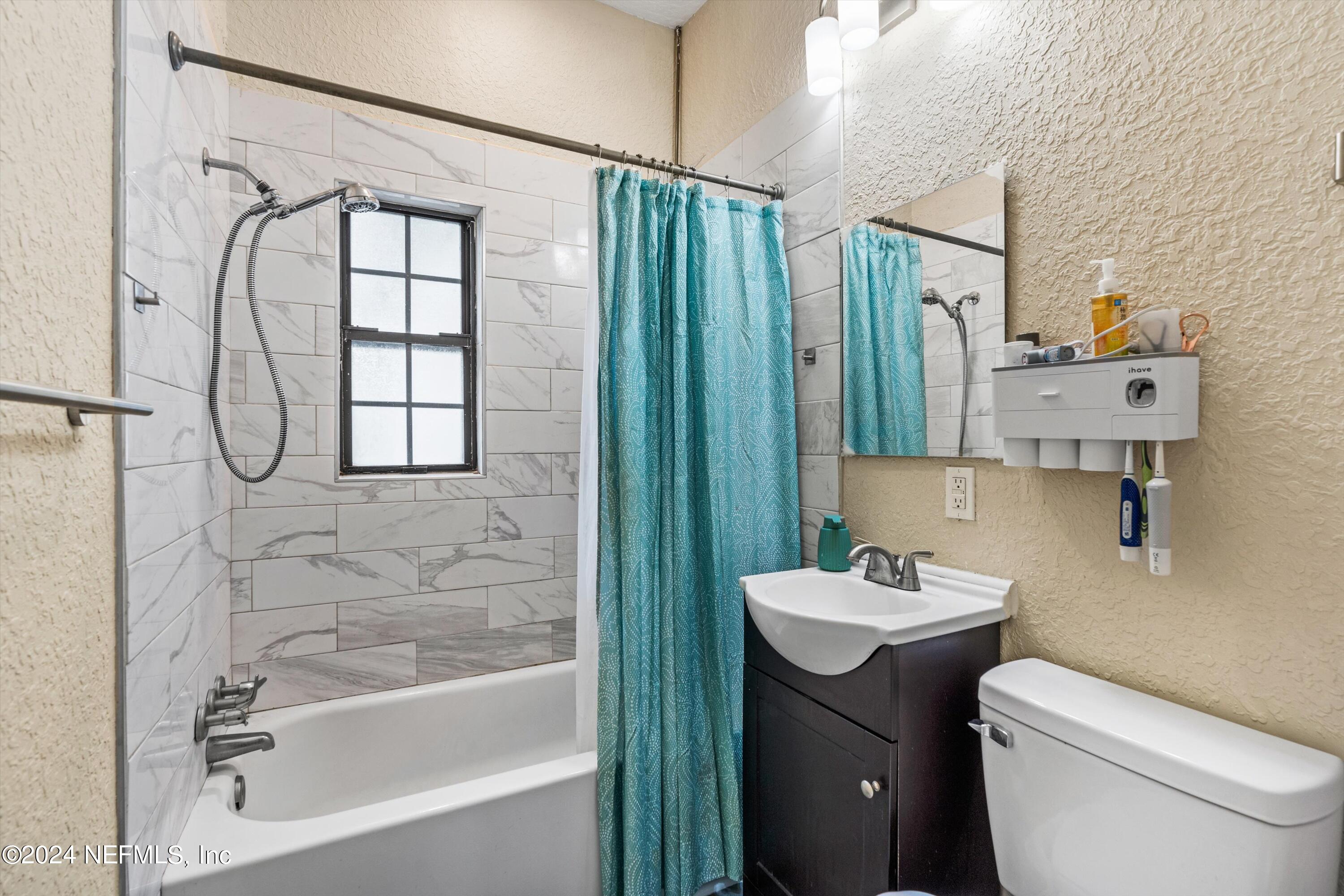1824 Griflet Road Jacksonville, FL 32211 - Photo 10 of 19 a bathroom with a sink a toilet and shower