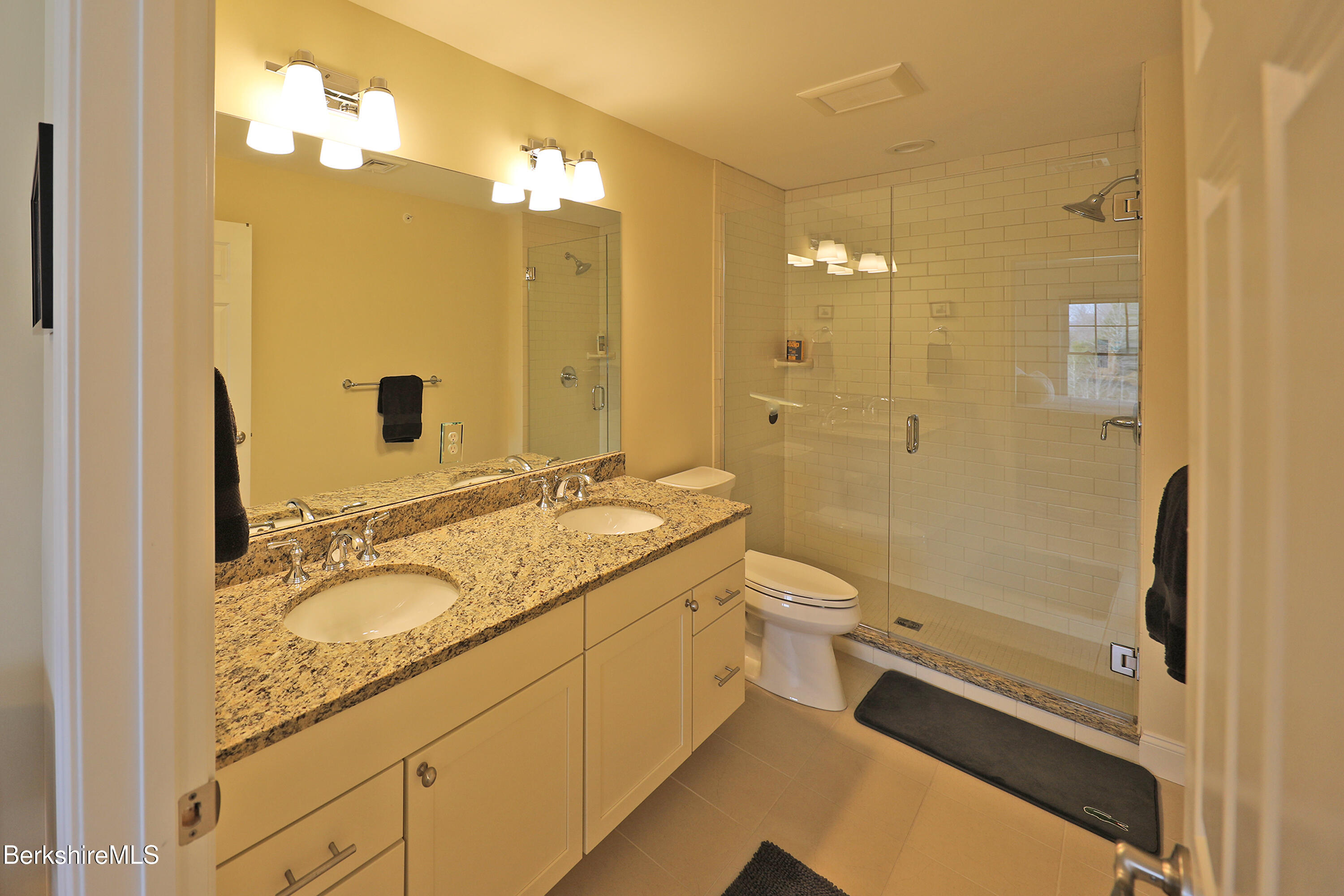 127 Alpine Trail Pittsfield, MA 01201 - Photo 38 of 54 a bathroom with a granite countertop sink a toilet a mirror and shower