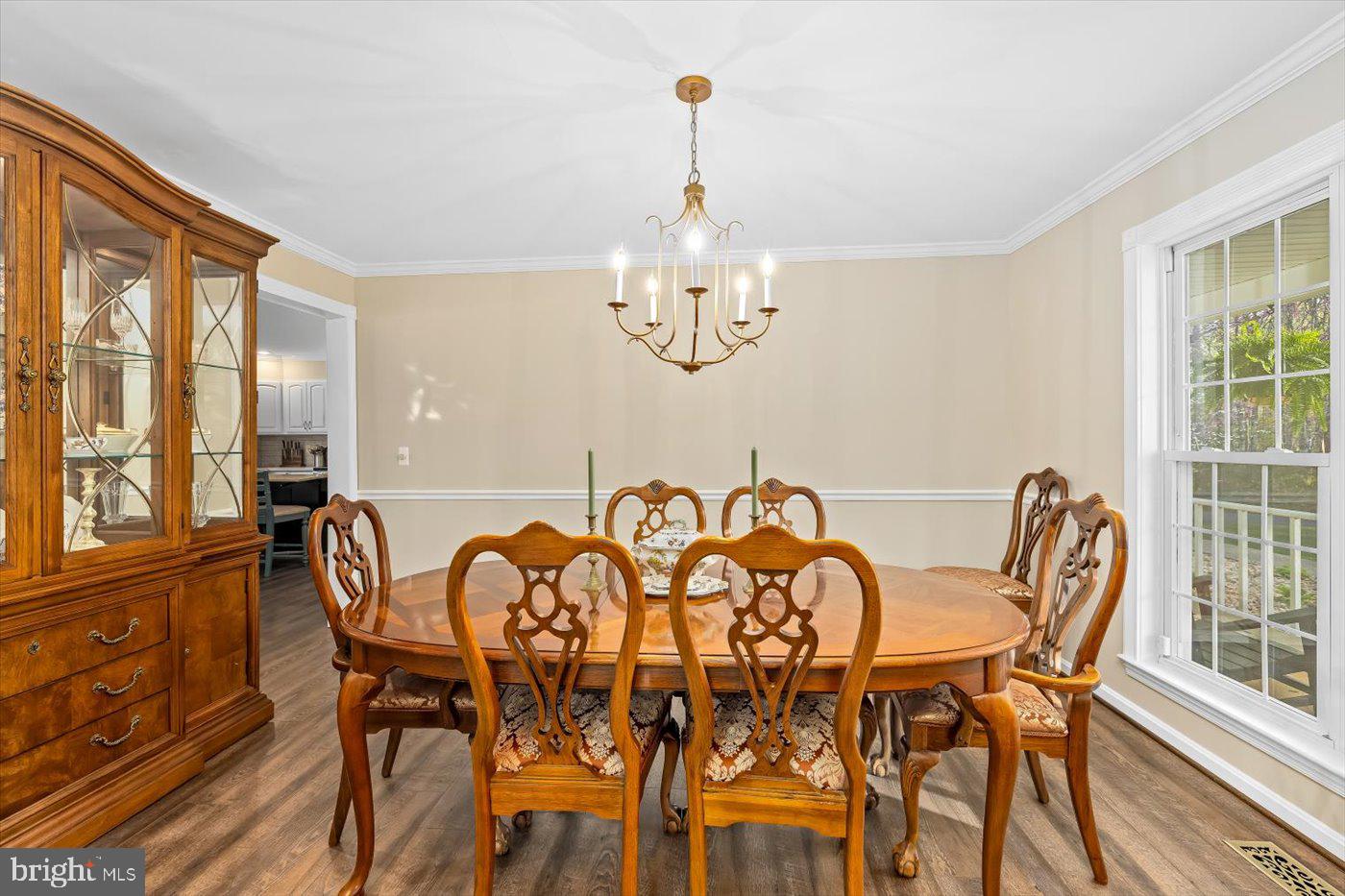 13037 Orange Plank Road Locust Grove, VA 22508 - Photo 17 of 71 a view of a dining room with furniture a chandelier and wooden floor