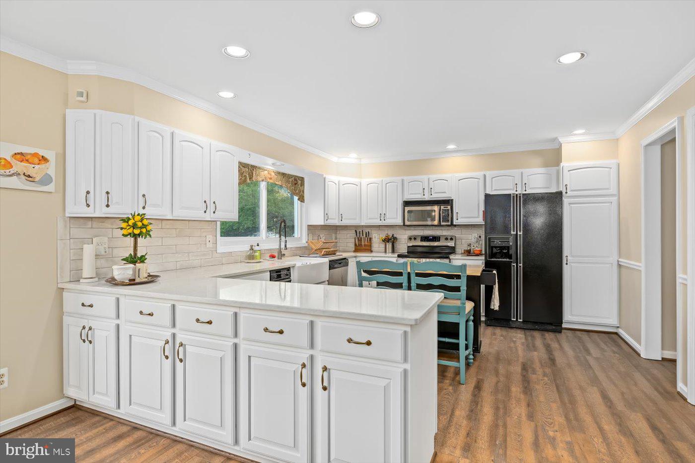 13037 Orange Plank Road Locust Grove, VA 22508 - Photo 19 of 71 a kitchen with white cabinets sink and stainless steel appliances