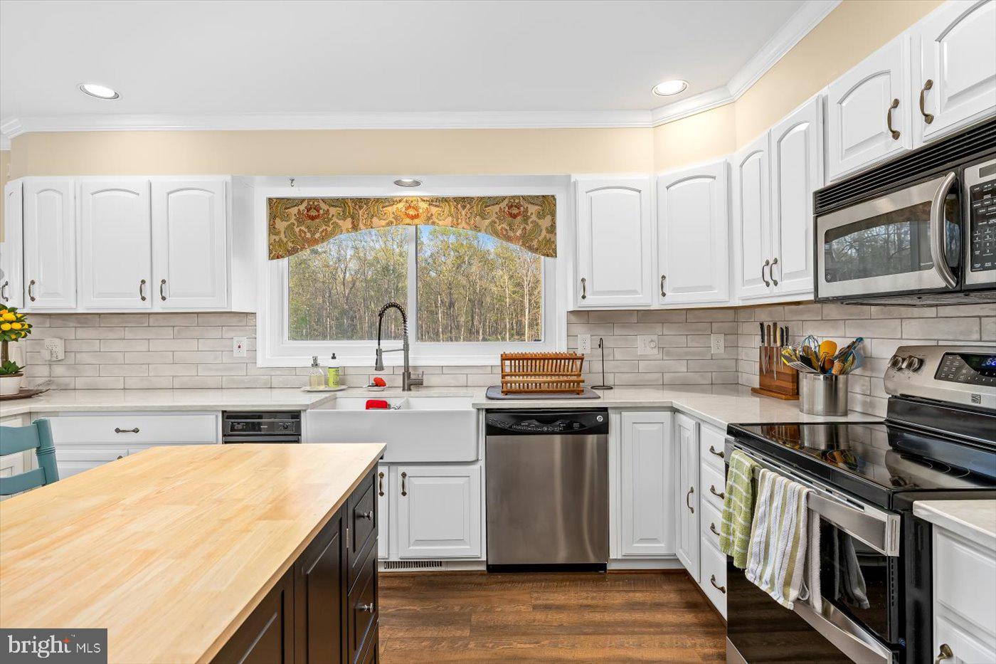 13037 Orange Plank Road Locust Grove, VA 22508 - Photo 22 of 71 a kitchen that has a sink and a stove in it
