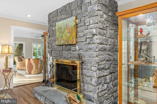 a bedroom with a bed a couch and paintings on the wall