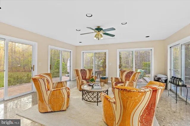 a living room with furniture and a book shelf