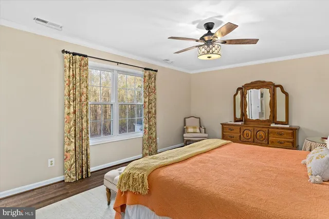 a view of a house with a big yard and large trees