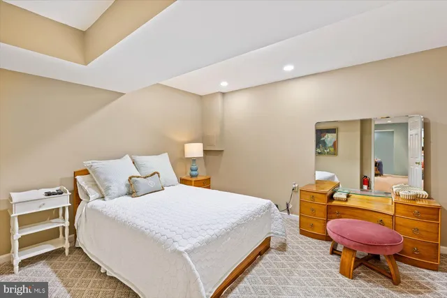 a front view of a house with a garden and trees