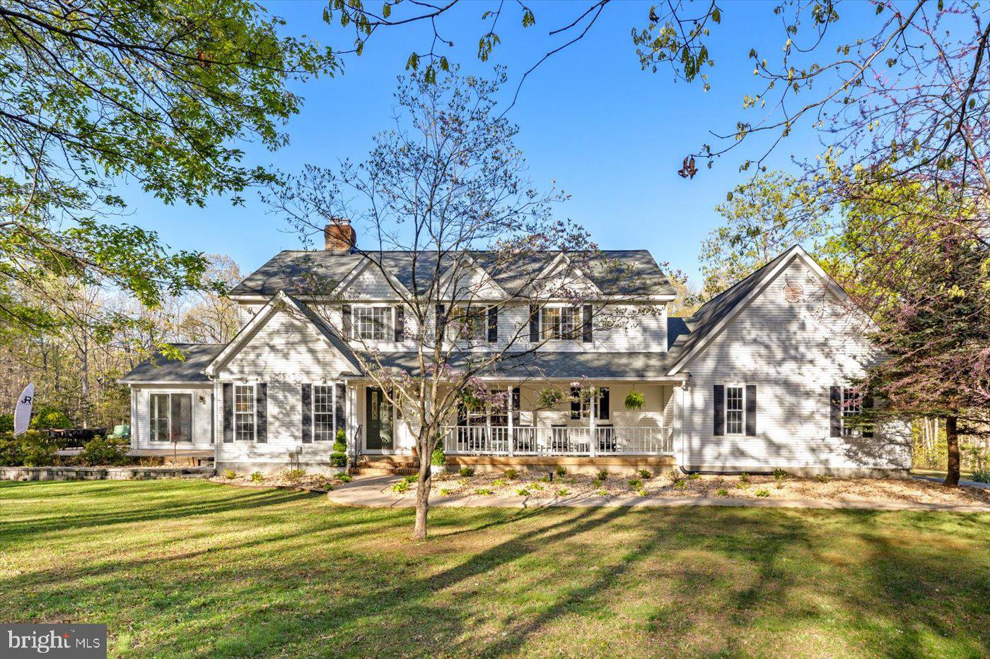 13037 Orange Plank Road Locust Grove, VA 22508 - Photo 5 of 71 a front view of a building with a garden