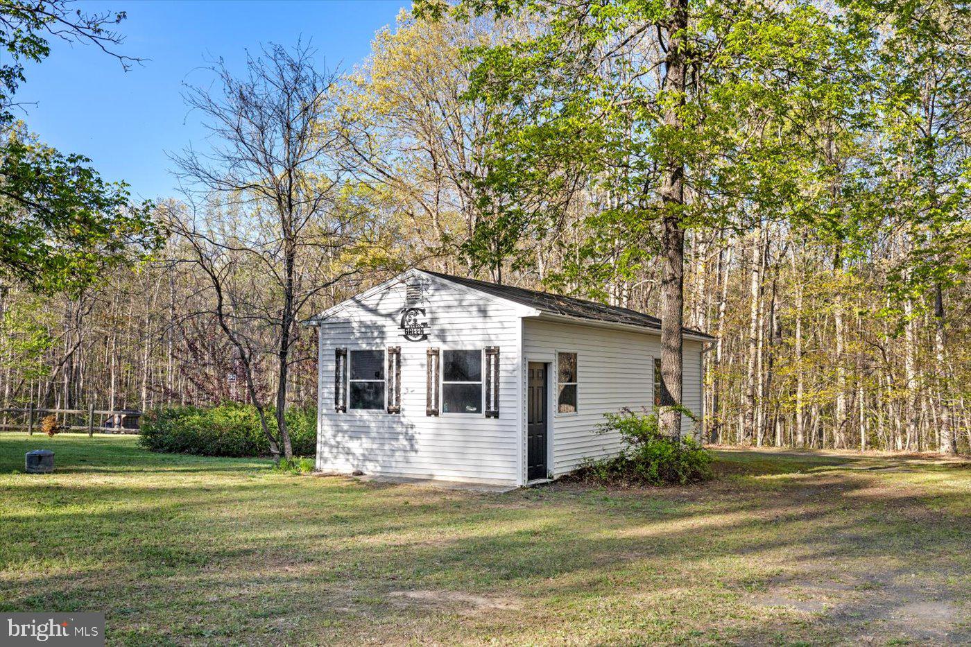 13037 Orange Plank Road Locust Grove, VA 22508 - Photo 61 of 71 a front view of a house with a garden and trees