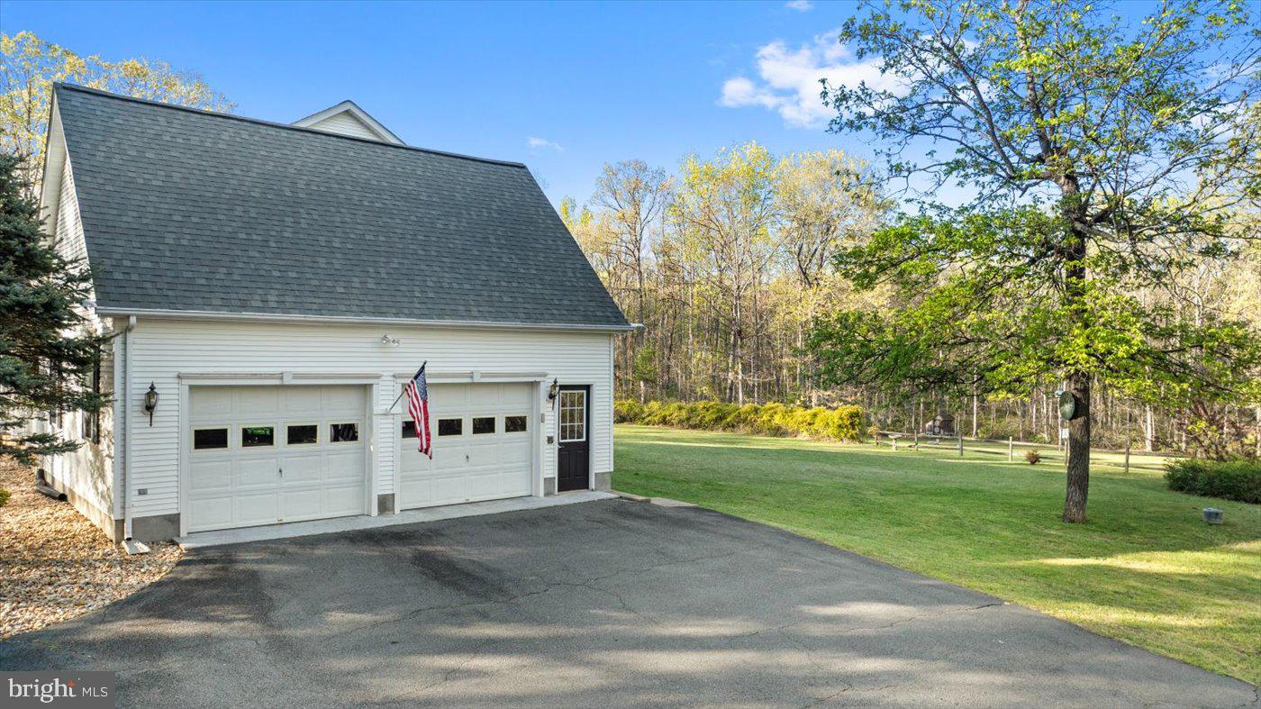 13037 Orange Plank Road Locust Grove, VA 22508 - Photo 10 of 71 a view of a white house with a large tree