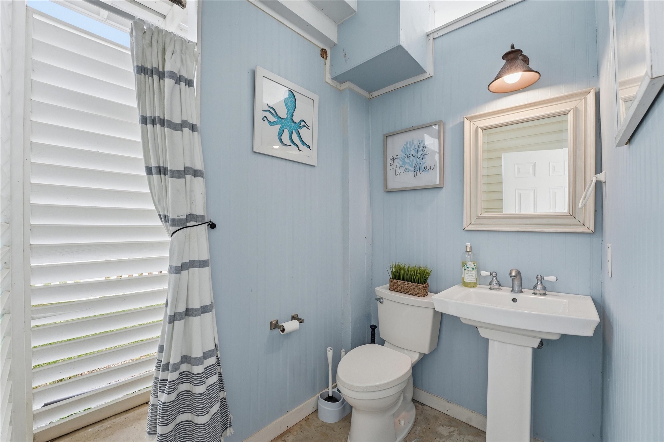 16635 Jamaica Cove Road Jamaica Beach, TX 77554 - Photo 31 of 45 a bathroom with a toilet sink and mirror
