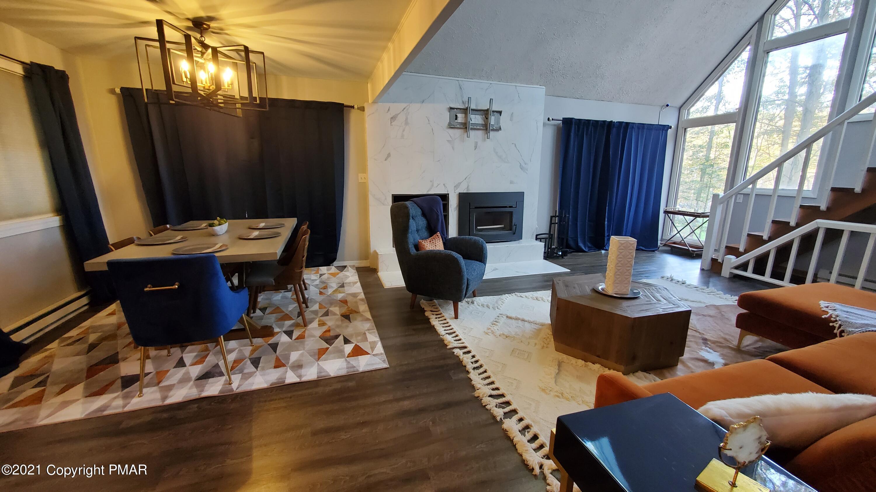 2111 Southport Drive Bushkill, PA 18324 - Photo 15 of 30 a living room with furniture a large window and a fireplace