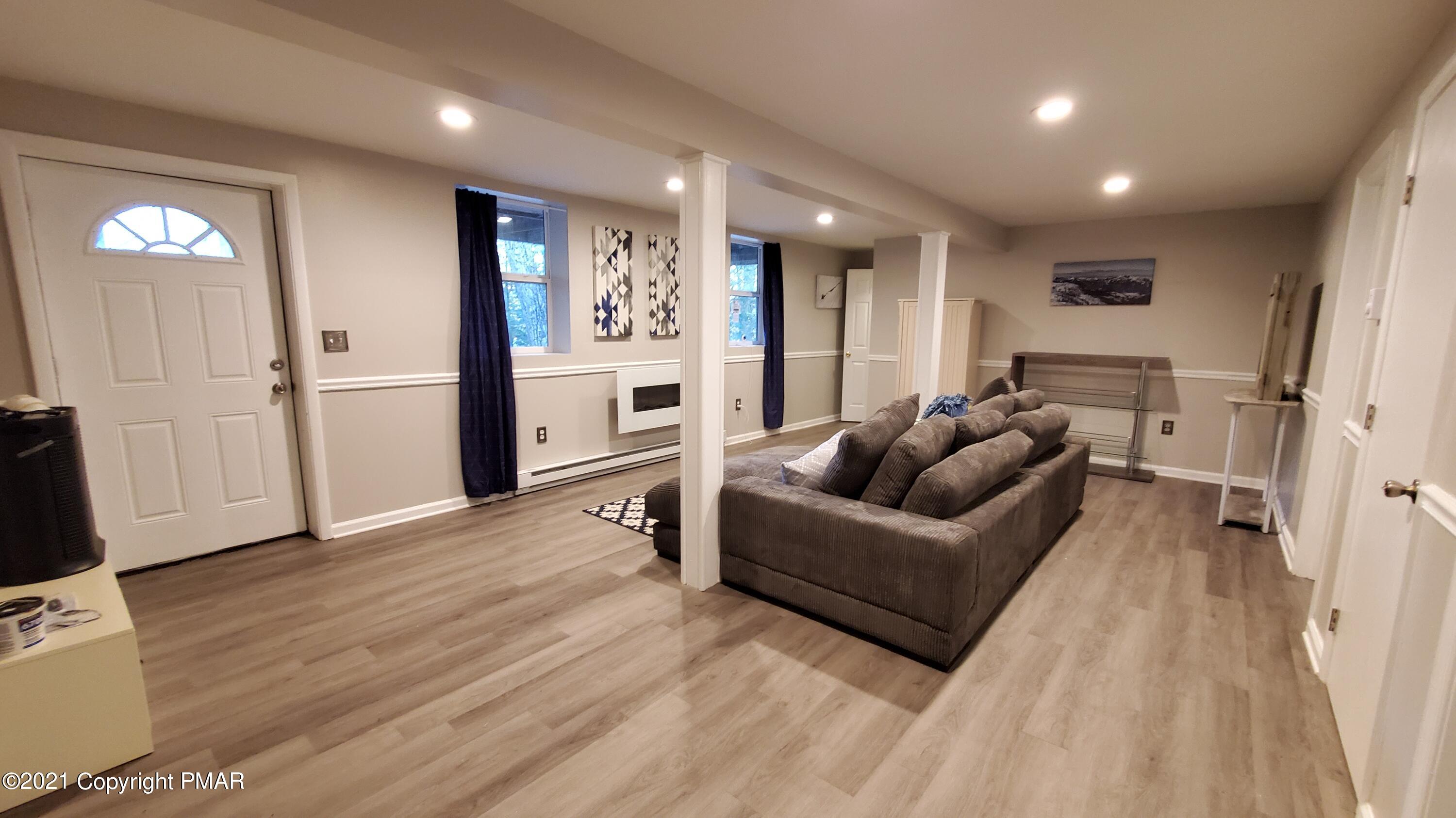 2111 Southport Drive Bushkill, PA 18324 - Photo 19 of 30 a living room with furniture and a flat screen tv