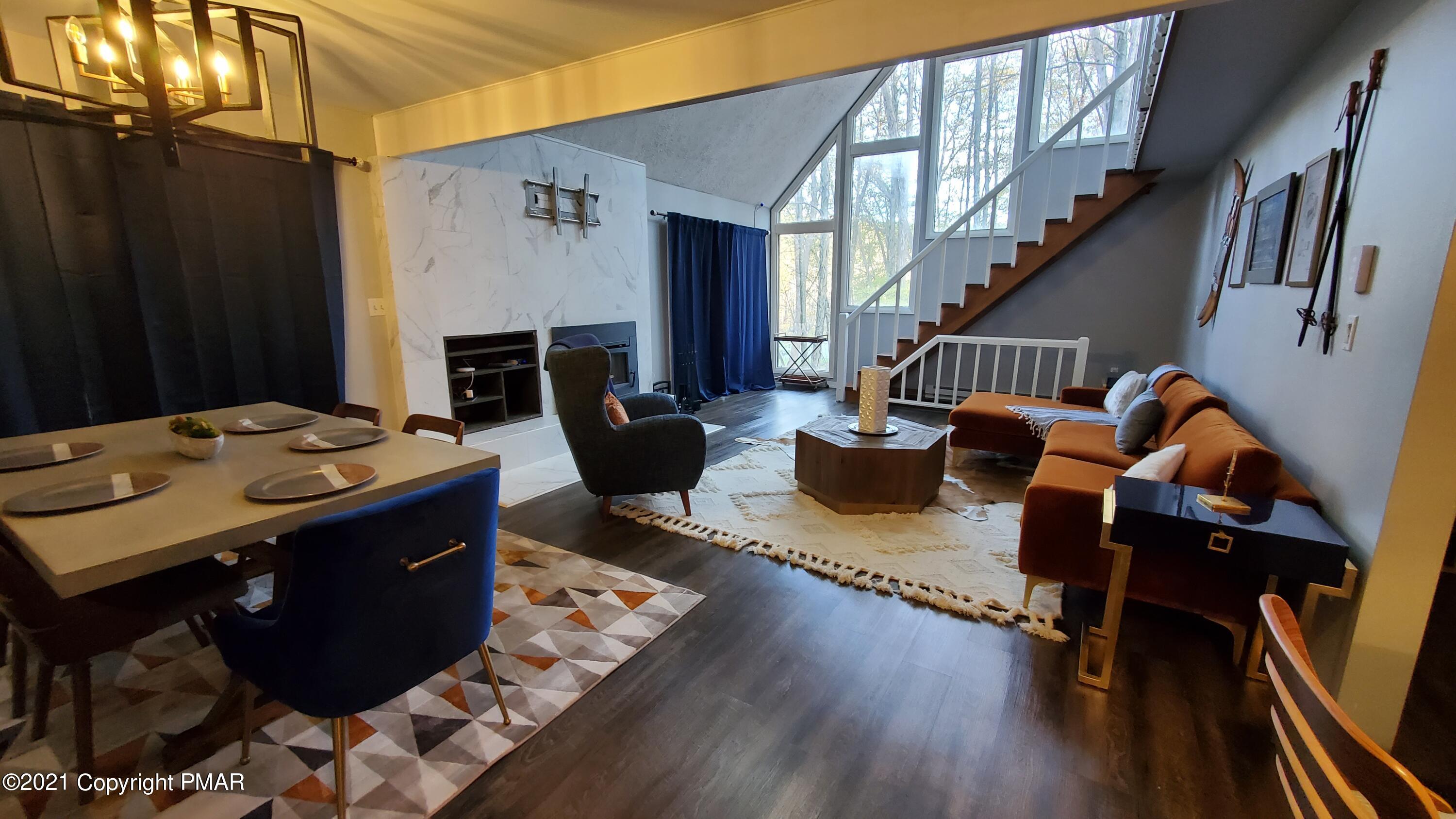 2111 Southport Drive Bushkill, PA 18324 - Photo 20 of 30 a view of a livingroom with furniture a fireplace and wooden floor