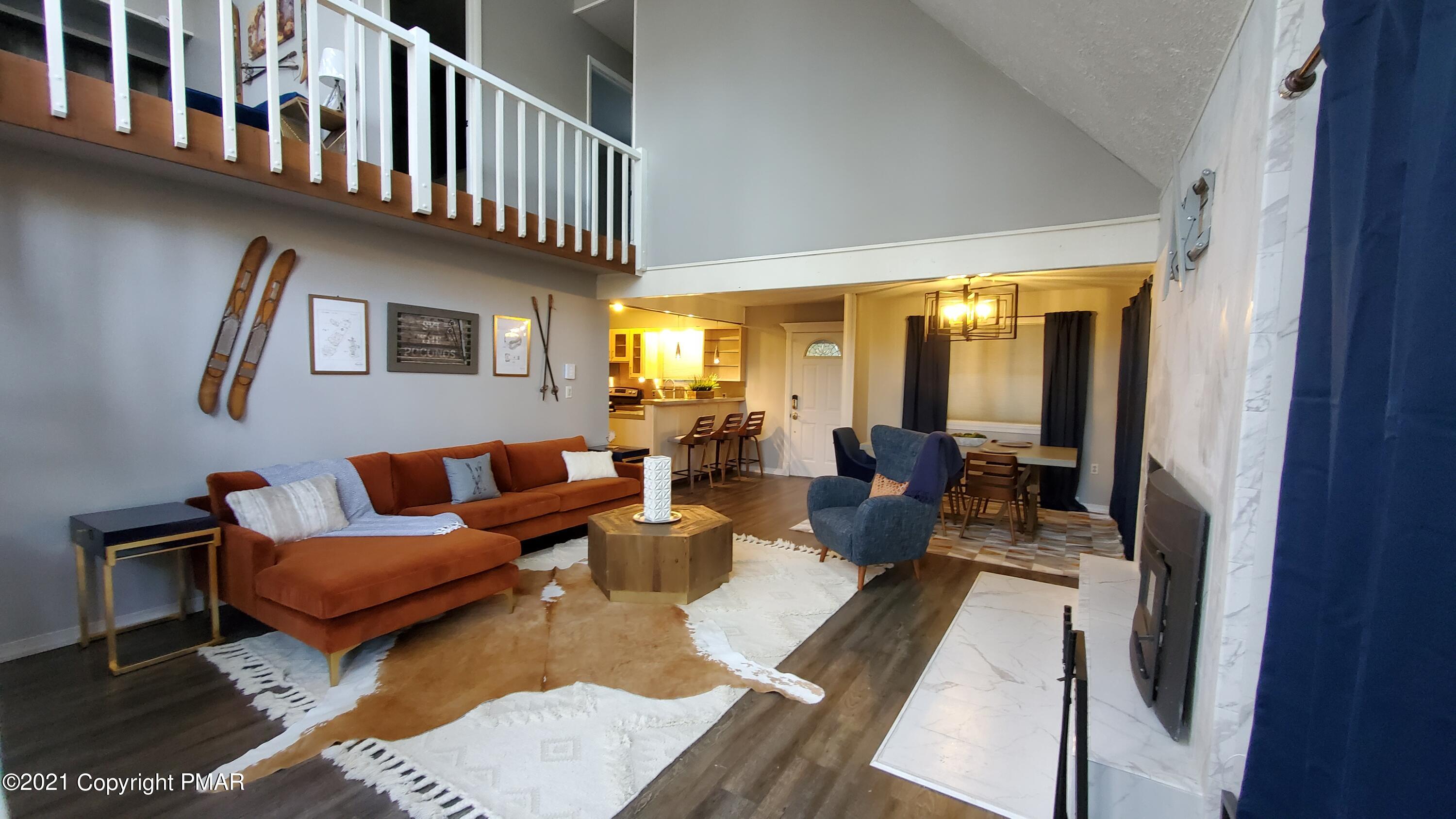 2111 Southport Drive Bushkill, PA 18324 - Photo 2 of 30 a living room with furniture wooden floor and a chandelier