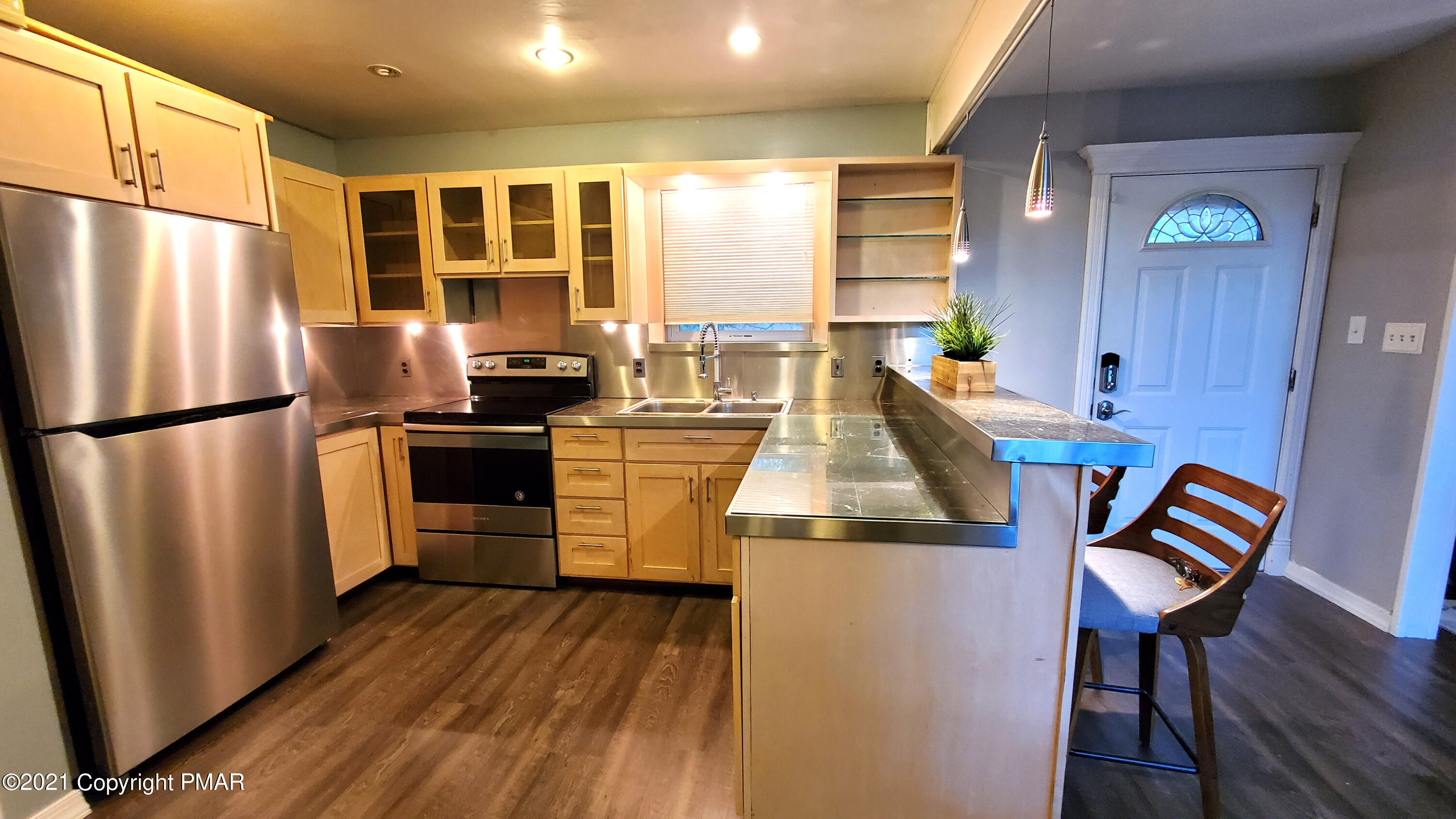 2111 Southport Drive Bushkill, PA 18324 - Photo 23 of 30 a kitchen with stainless steel appliances granite countertop a refrigerator a stove and a wooden floors