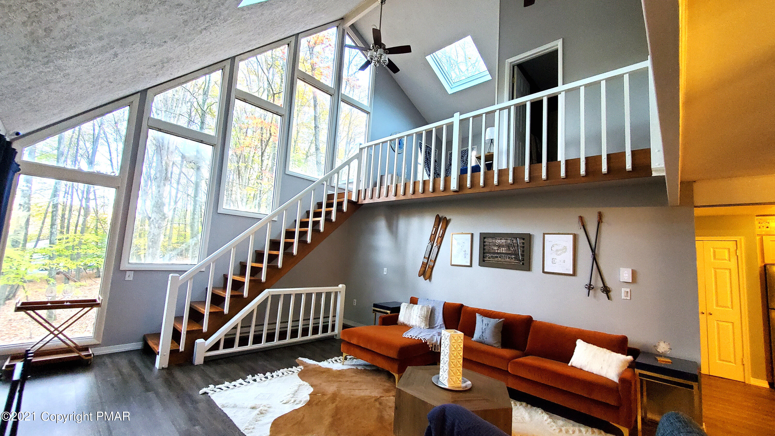 2111 Southport Drive Bushkill, PA 18324 - Photo 25 of 30 a living room with furniture staircase and a dining table next to a window