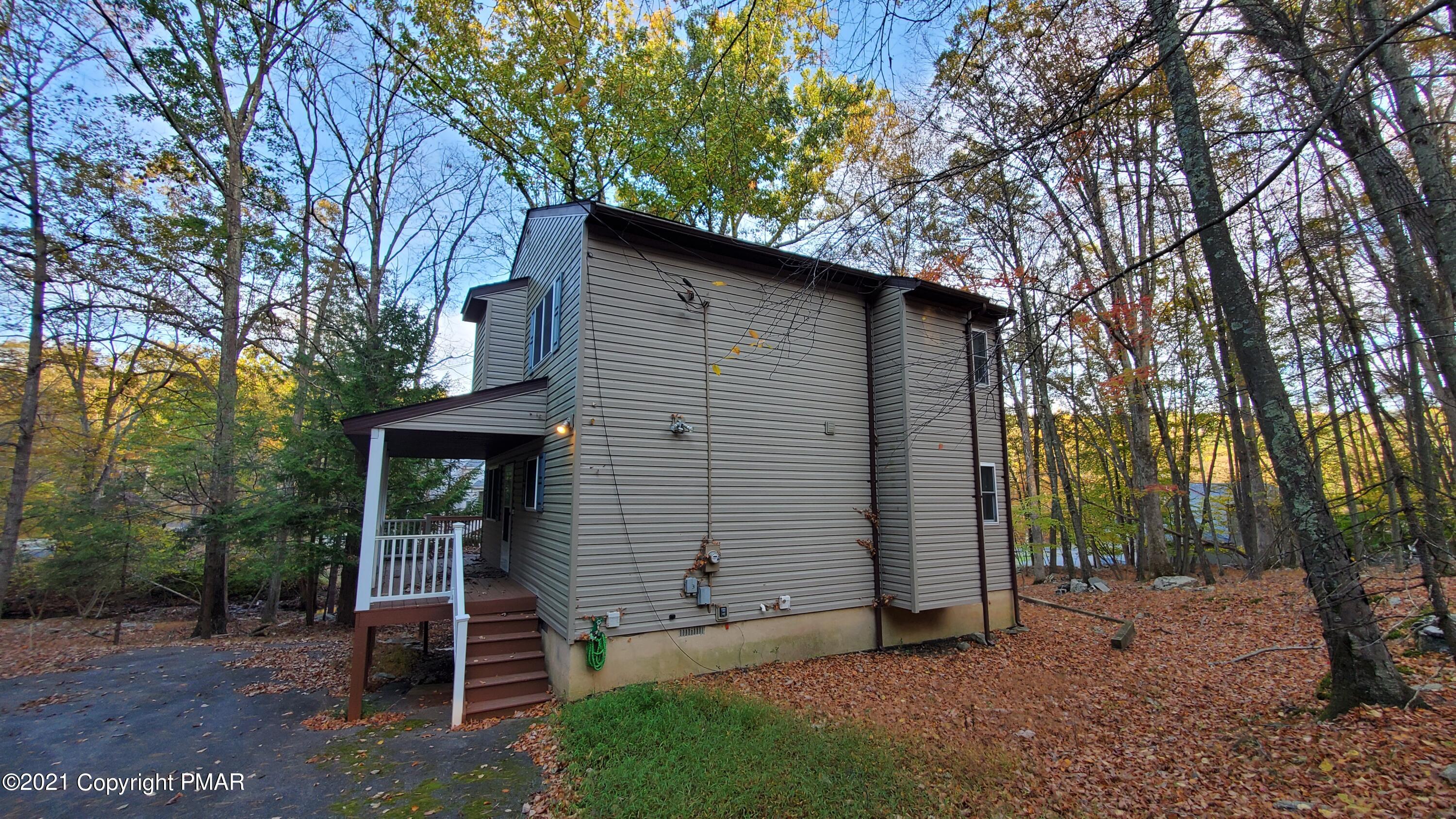 2111 Southport Drive Bushkill, PA 18324 - Photo 26 of 30 a backyard of a house with barbeque oven and large trees