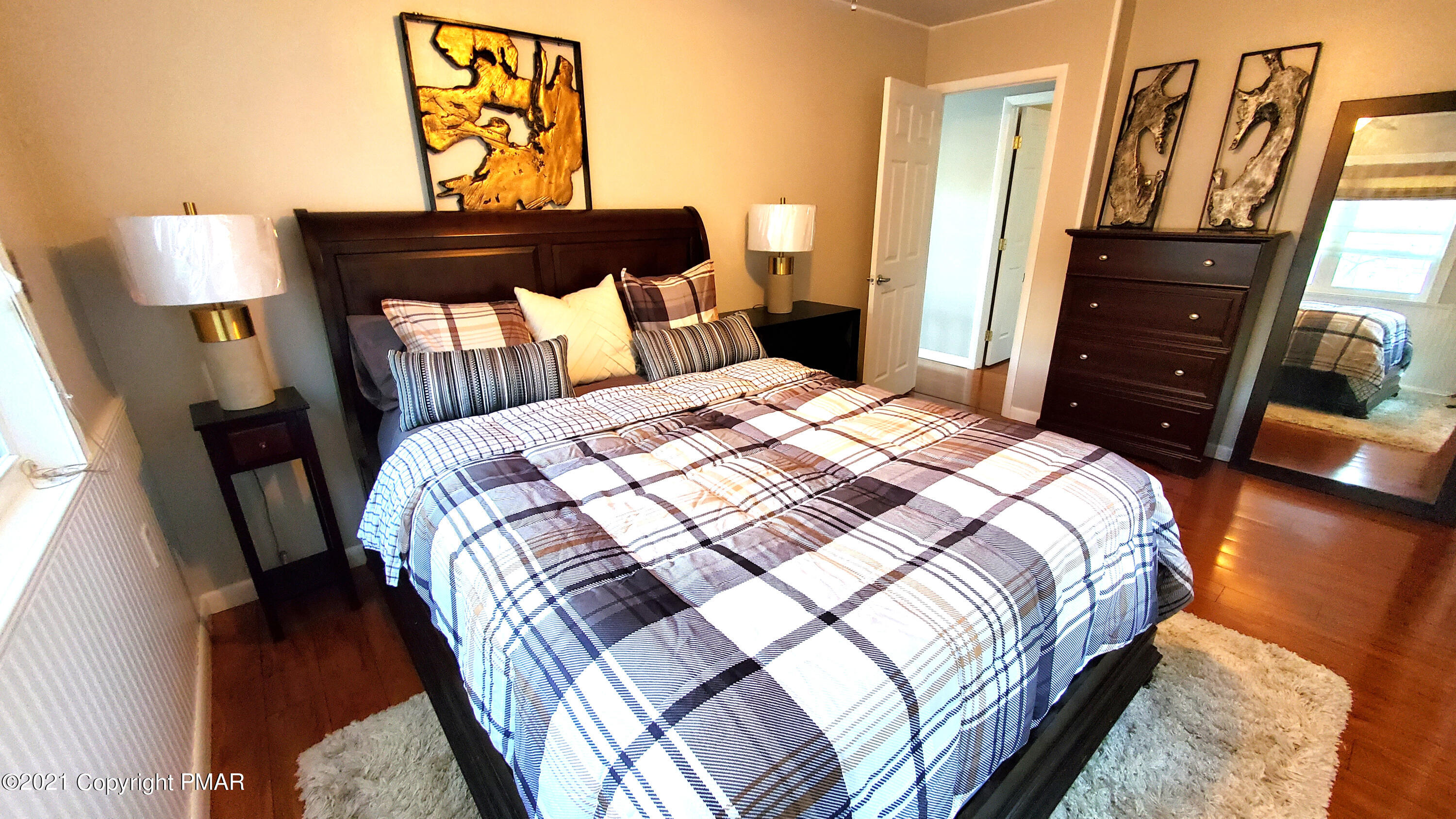 2111 Southport Drive Bushkill, PA 18324 - Photo 9 of 30 a bedroom with a bed and a lamp on dresser