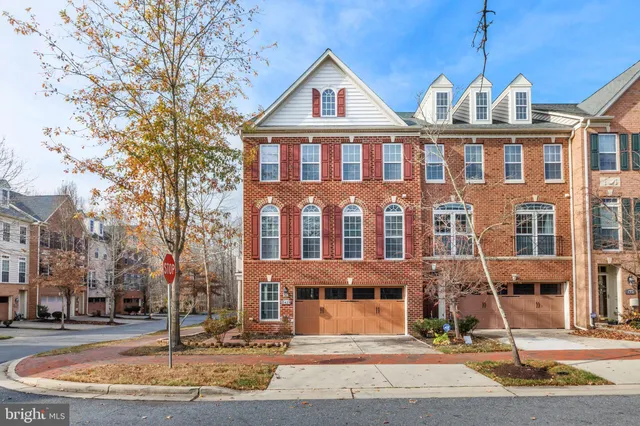 a front view of a residential apartment building with a yard