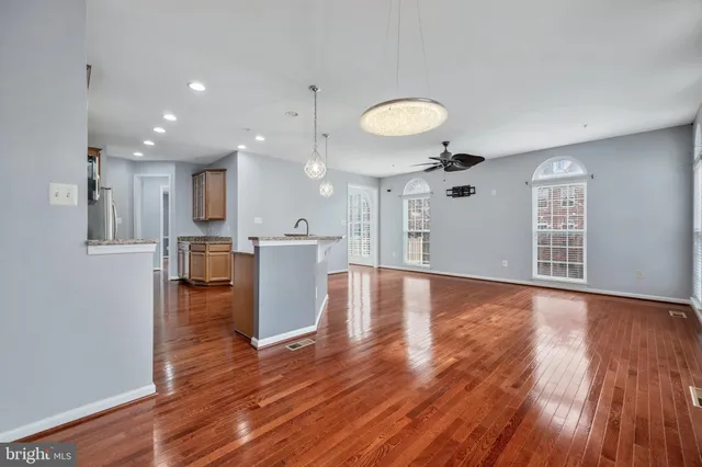 a kitchen with granite countertop stainless steel appliances a refrigerator and cabinets