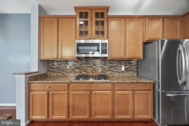 a kitchen with center island wooden floor and a chandelier