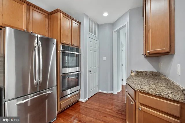 a view of staircase with wooden floor and a chandelier