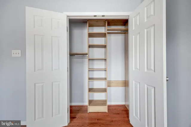 a view of walk in closet with empty racks