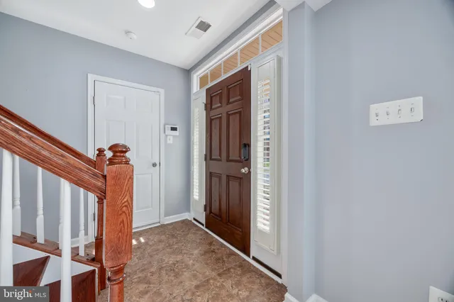 a kitchen with stainless steel appliances granite countertop a sink a stove and a wooden floors