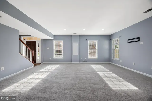 a view of a livingroom with wooden floor and a chandelier
