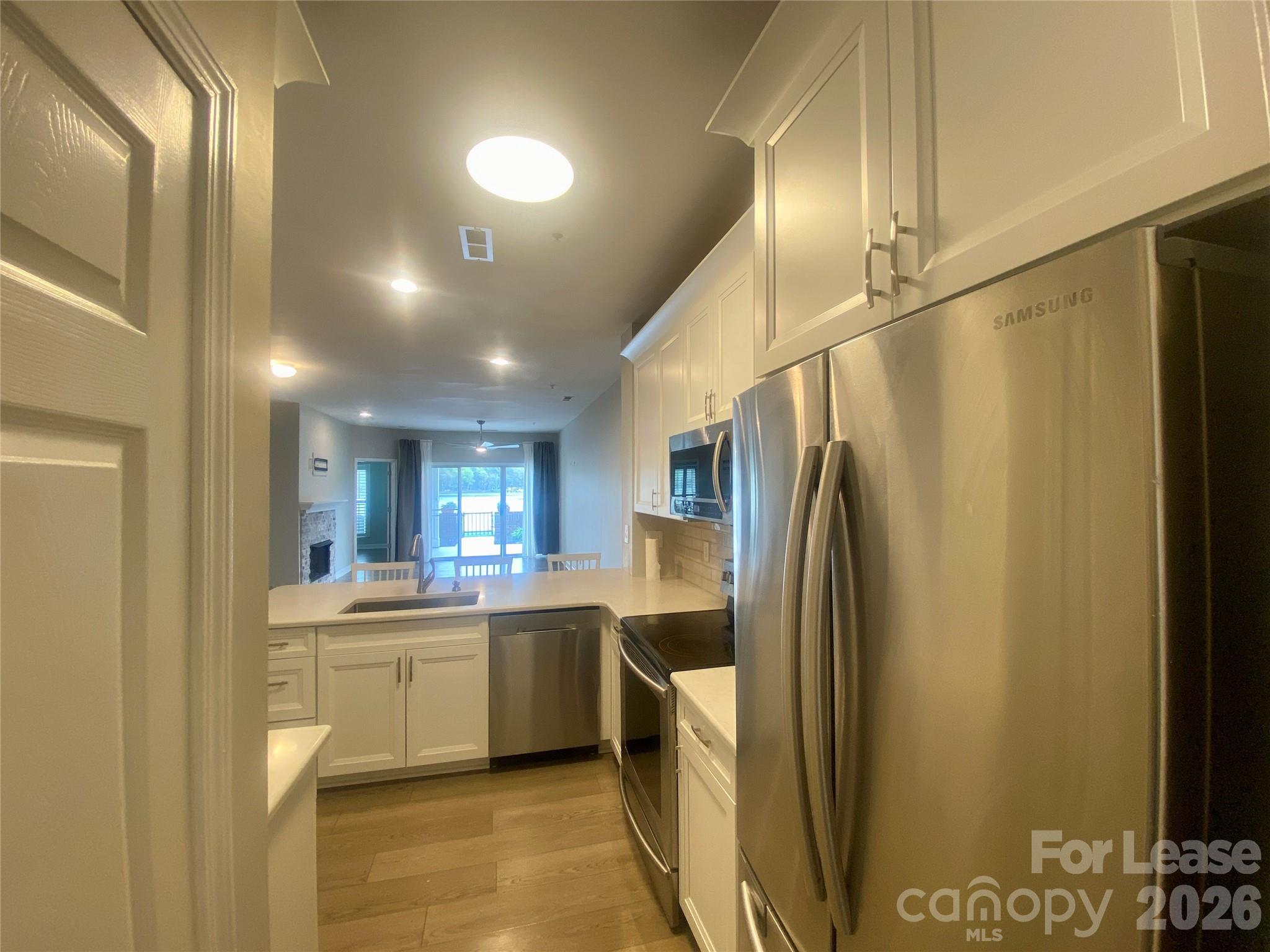 920 Jetton Street, Unit 49 Davidson, NC 28036 - Photo 11 of 33 a kitchen with stainless steel appliances a refrigerator and a sink