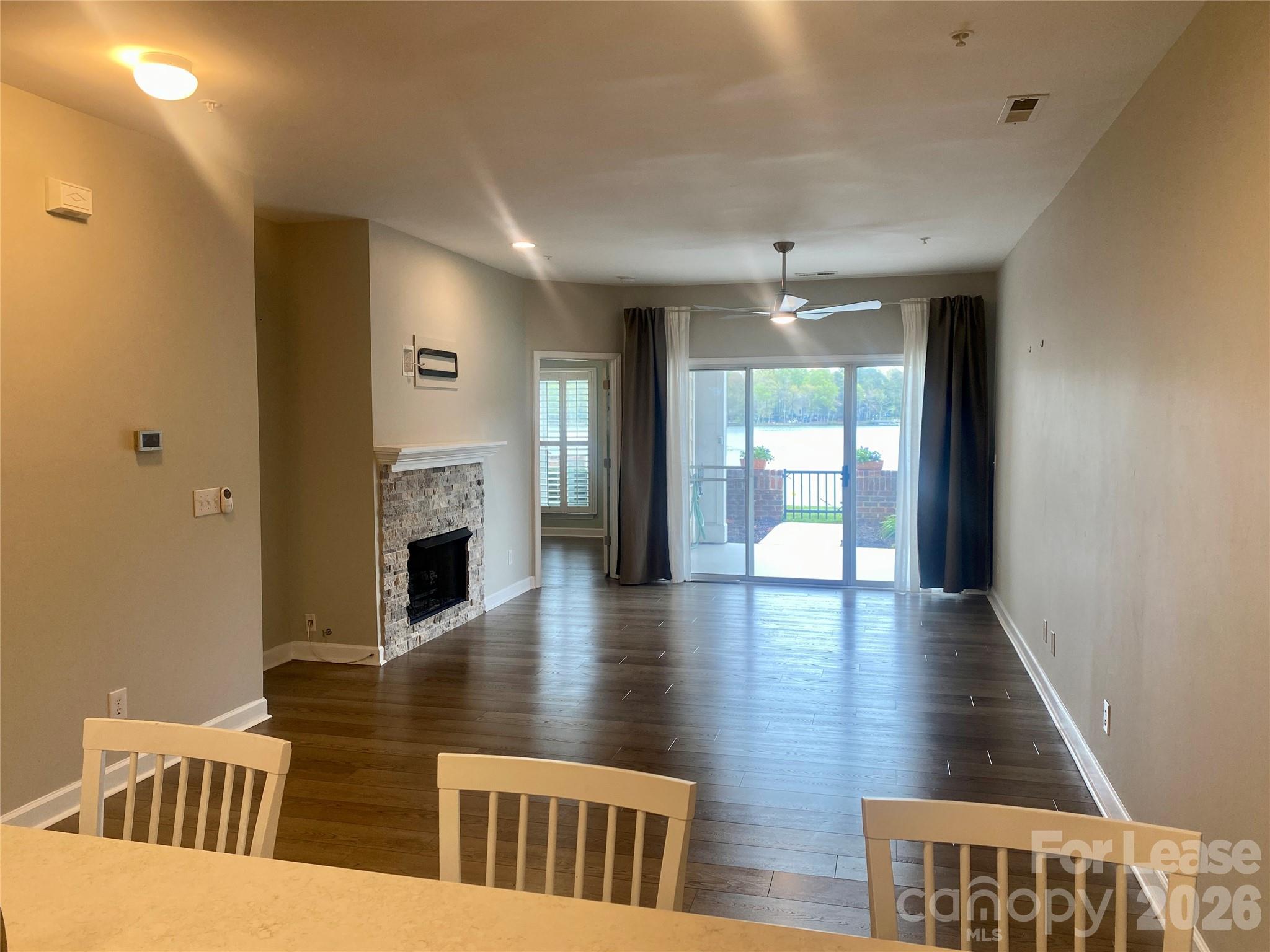 920 Jetton Street, Unit 49 Davidson, NC 28036 - Photo 13 of 33 a view of a livingroom with furniture hardwood floor and a ceiling fan