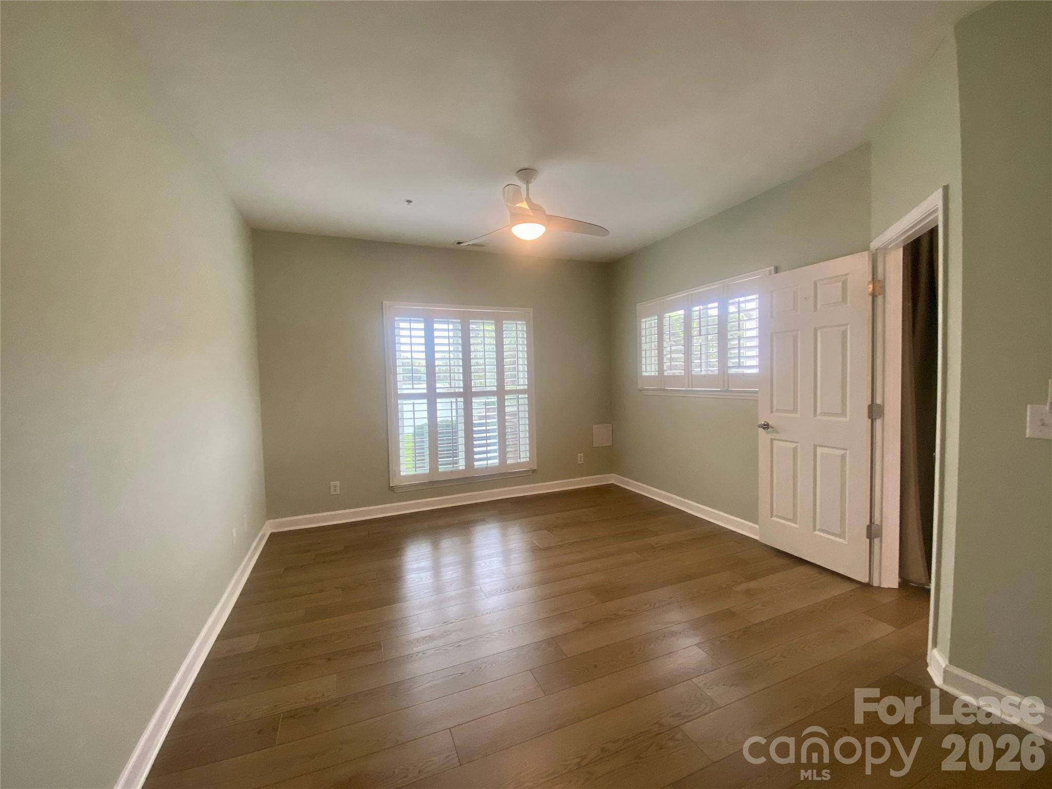 920 Jetton Street, Unit 49 Davidson, NC 28036 - Photo 15 of 33 an empty room with wooden floor and windows