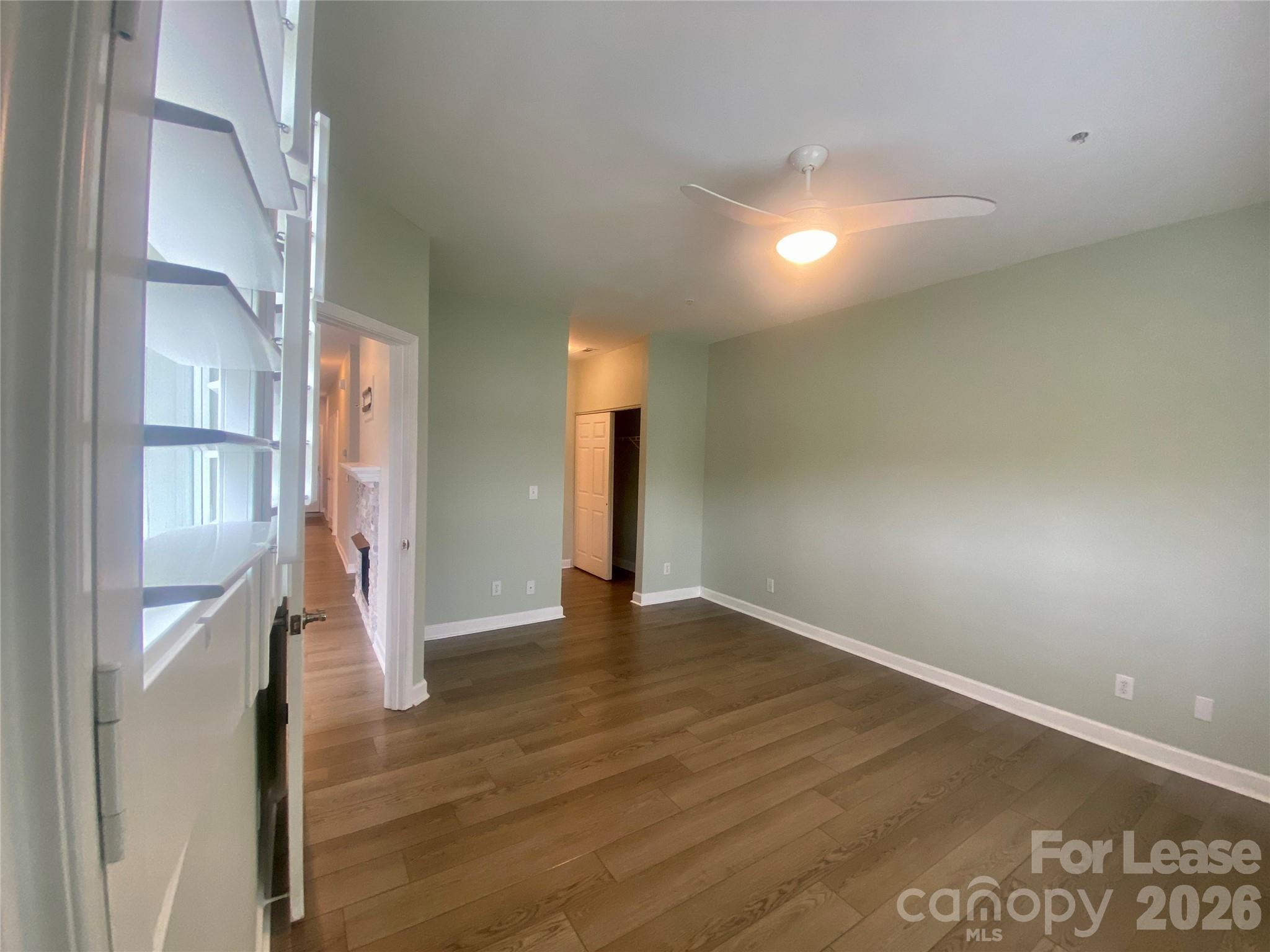 920 Jetton Street, Unit 49 Davidson, NC 28036 - Photo 16 of 33 a view of an empty room with wooden floor and a window