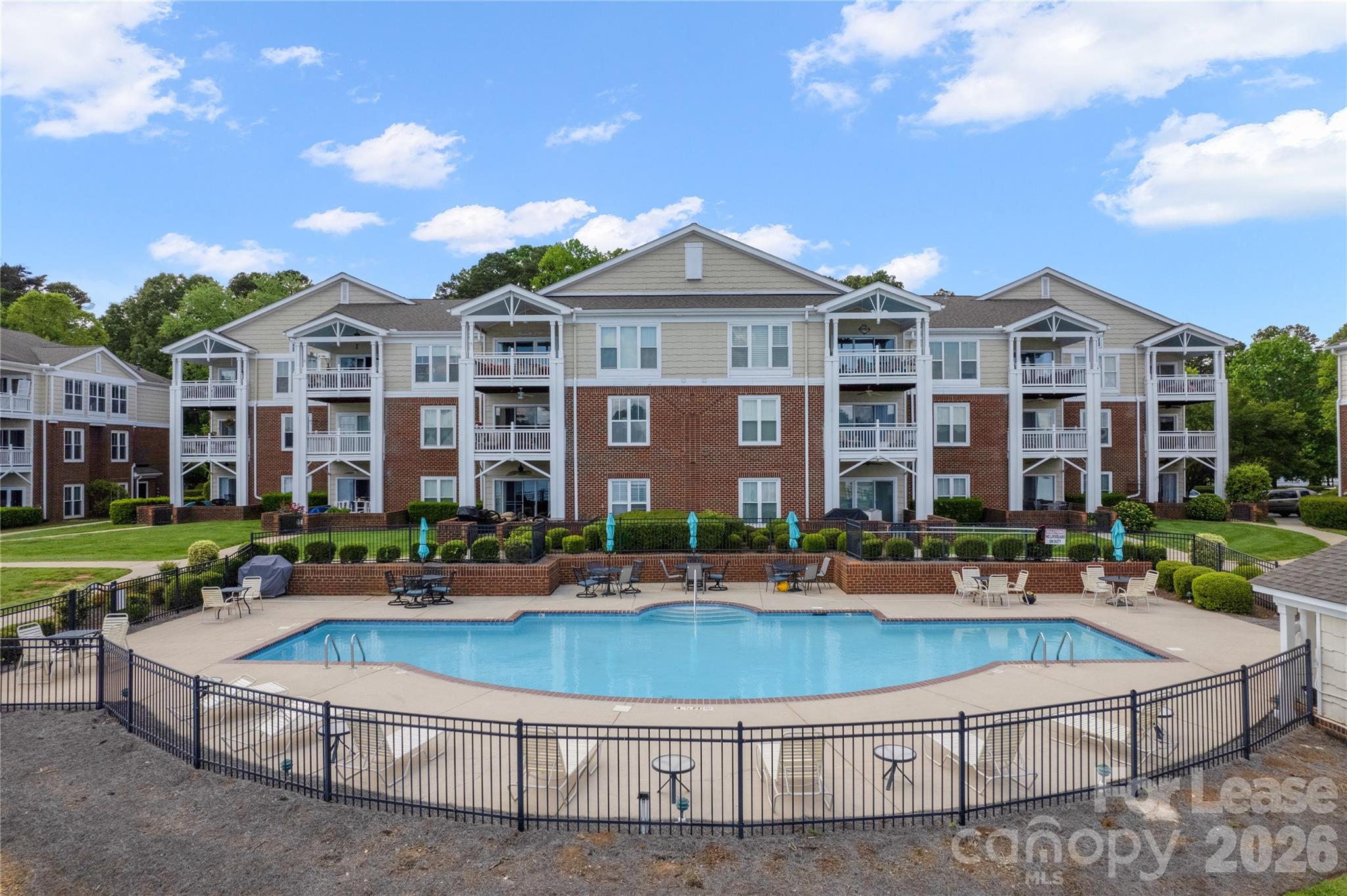 920 Jetton Street, Unit 49 Davidson, NC 28036 - Photo 4 of 33 a front view of building with yard and outdoor seating