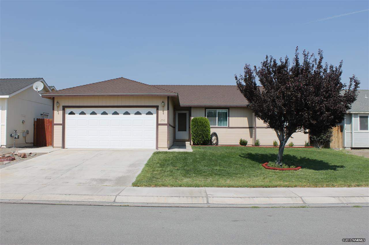 250 Emigrant Way Fernley, NV 89408 - Photo 1 of 1 a front view of a house with a yard and garage