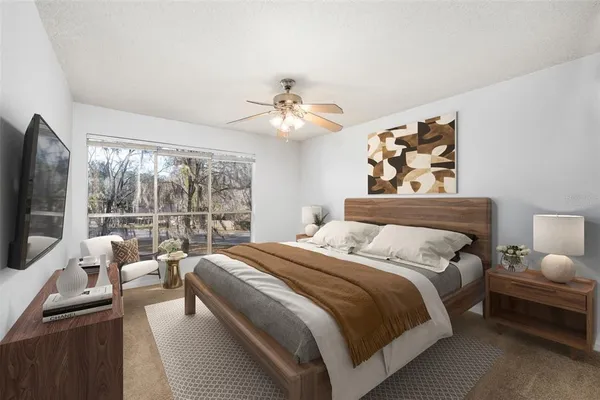 a bedroom with a bed and a flat screen tv