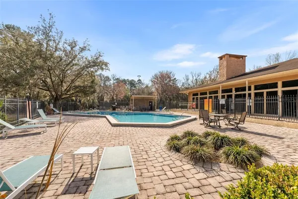 a view of a house with backyard porch and sitting area