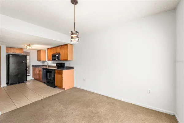 a kitchen with a refrigerator and a sink
