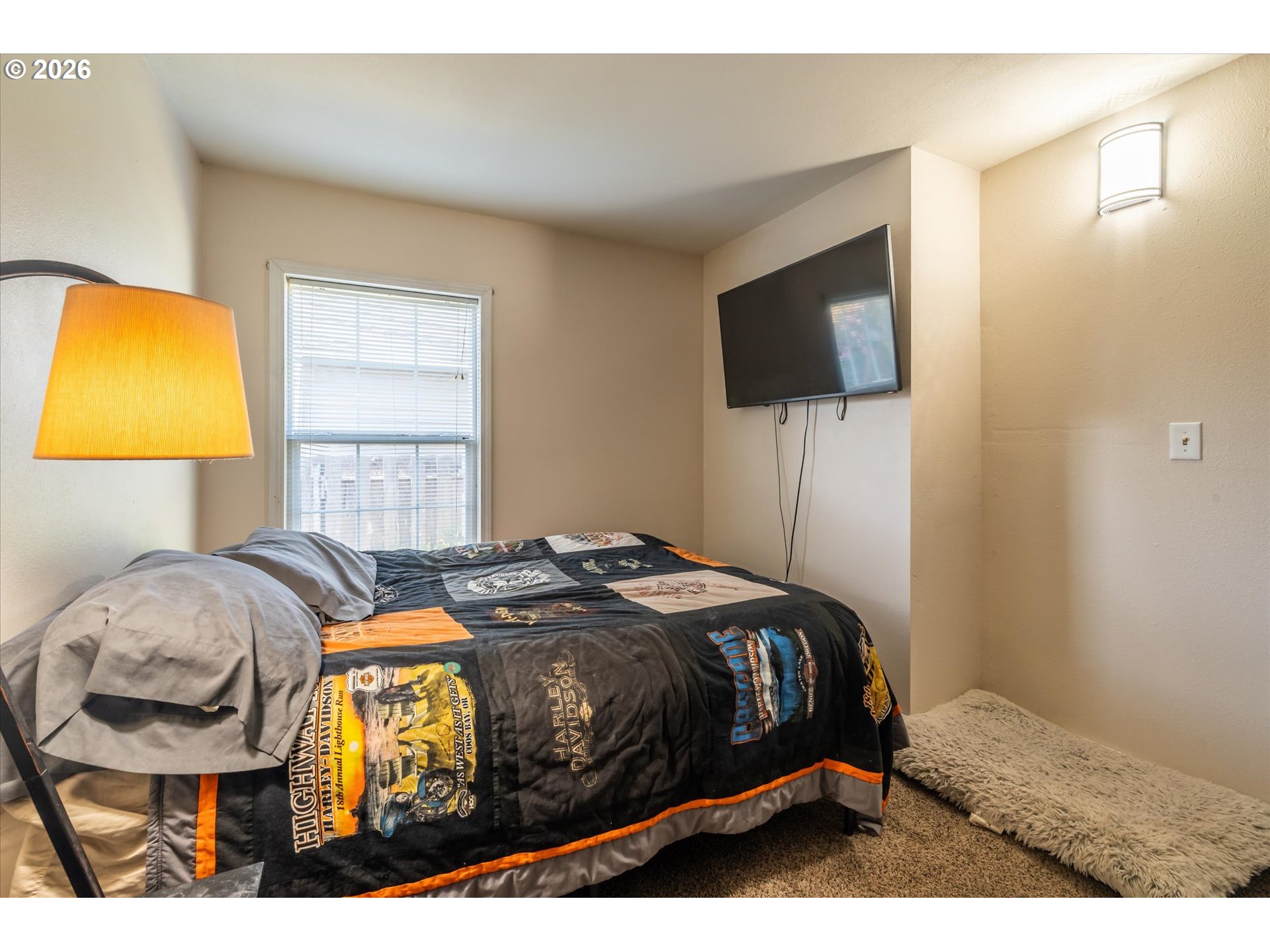 1789 14th Street North Bend, OR 97459 - Photo 29 of 43 a bedroom with a bed and flat screen tv