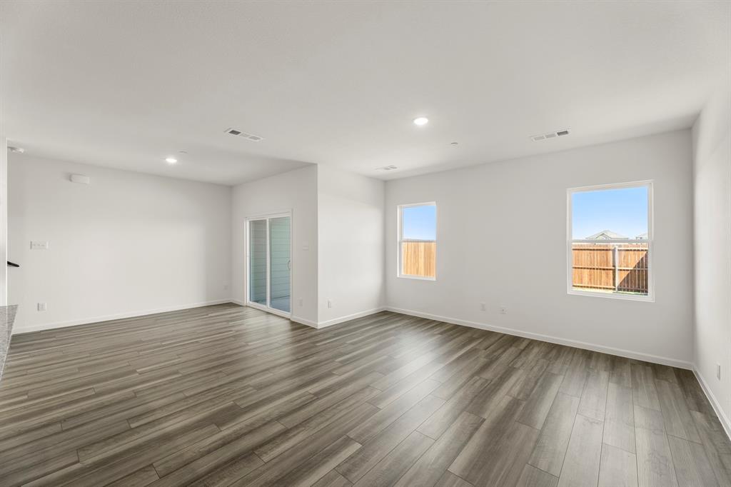 1444 Lake Alpine Trail Anna, TX 75409 - Photo 11 of 29 a view of an empty room with wooden floor and a window